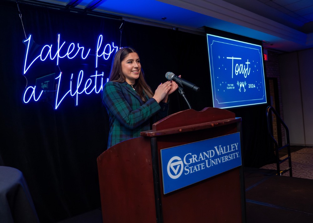 Girl stands in front of microphone and claps